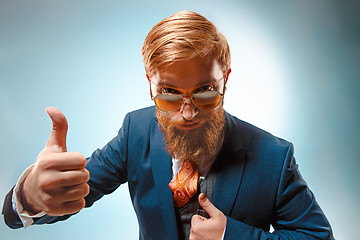 Image showing Portrait of a business man isolated on blue background.