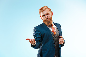 Image showing Portrait of a business man isolated on blue background.