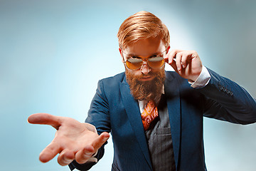 Image showing Portrait of a business man isolated on blue background.