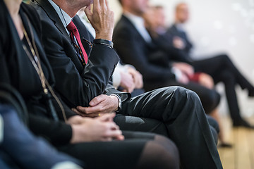 Image showing Row of business people sitting at seminar.