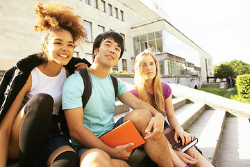 Image showing cute group of teenages at the building of university with books huggings, back to school