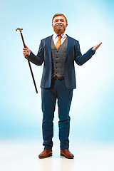 Image showing The barded man in a suit holding cane.