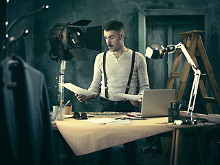 Image showing Architect working on drawing table in office