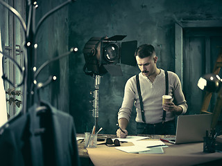 Image showing Architect working on drawing table in office