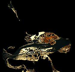 Image showing Melted gold or oil splashes isolated on black