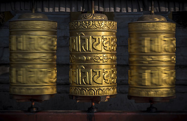 Image showing Buddhist shiny prayer wheels in motion