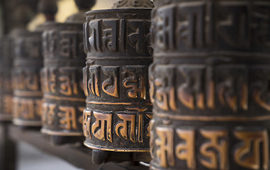 Image showing Buddhism obsolete prayer wheels in row 