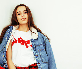 Image showing young pretty teenage hipster girl posing emotional happy smiling on white background, lifestyle people concept 