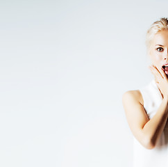 Image showing young pretty teenage hipster girl posing emotional happy smiling on white background, lifestyle people concept 