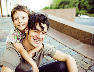 Image showing little son with father in city hagging and smiling, casual look