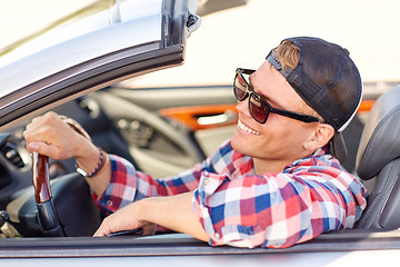 Image showing happy young man in shades driving convertible car