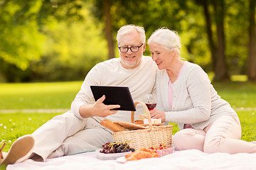 Image showing happy senior couple having picnic at summer park