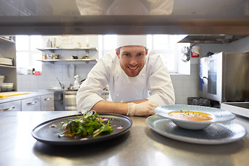 Image showing happy male chef cooking food at restaurant kitchen