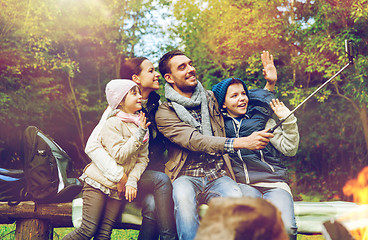 Image showing family with smartphone taking selfie near campfire