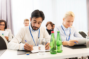 Image showing businesspeople with papers at conference