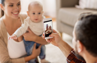 Image showing happy family with baby photographing at home