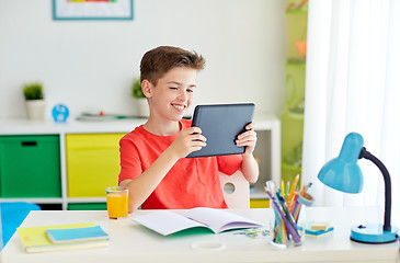 Image showing student boy with tablet pc and notebook at home