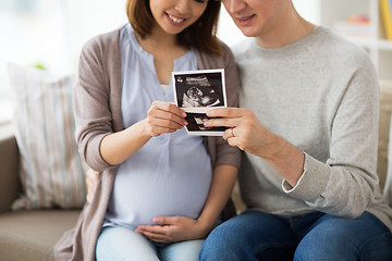 Image showing couple with baby ultrasound images at home