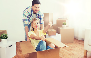 Image showing happy couple having fun with boxes at new home