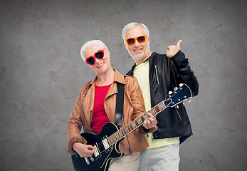 Image showing happy senior couple with guitar showing thumbs up