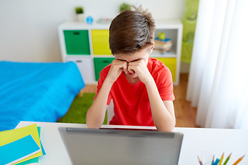 Image showing tired student boy with laptop computer at home