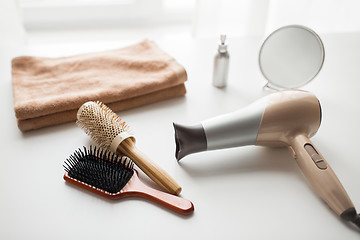 Image showing hairdryer, hair brushes, mirror and towel