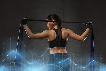 Image showing woman with expander exercising in gym