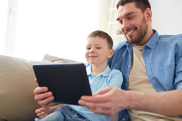 Image showing father and son with tablet pc playing at home