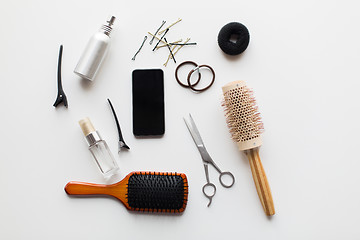 Image showing smartphone, scissors, brushes and other hair tools