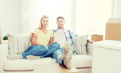 Image showing happy couple with big cardboard boxes at new home