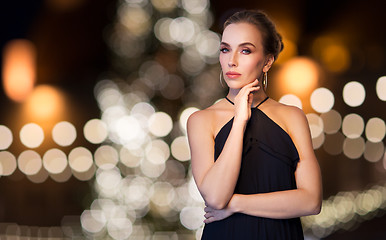 Image showing woman wearing jewelry over christmas lights