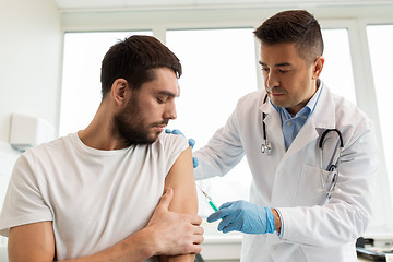 Image showing patient and doctor with syringe doing vaccination