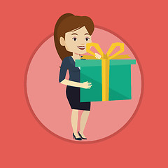 Image showing Joyful caucasian woman holding box with gift.