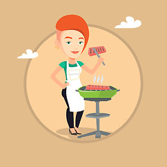 Image showing Woman cooking steak on barbecue grill.