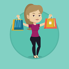 Image showing Happy woman holding shopping bags.