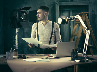 Image showing Architect working on drawing table in office