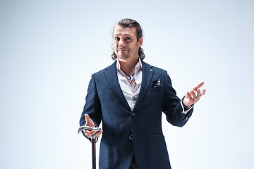 Image showing The mature barded man in a suit holding cane.