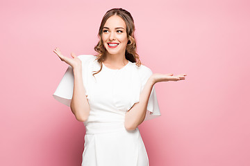 Image showing Surprised happy beautiful woman looking sideways in excitement.