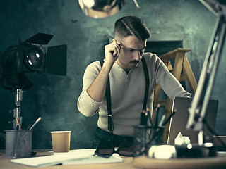 Image showing Architect working on drawing table in office