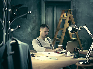 Image showing Architect working on drawing table in office