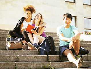 Image showing cute group of teenages at the building of university with books huggings, back to school