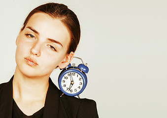 Image showing young beauty woman in business style costume waking up for work early morning on white background