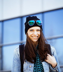 Image showing young pretty girl near business building walking