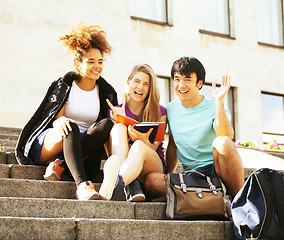 Image showing cute group of teenages at the building  university with books huggings, back to school