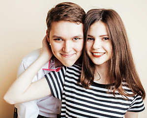 Image showing couple of happy smiling teenagers students, warm colors having a