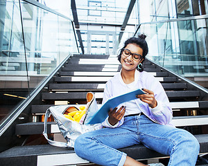 Image showing young cute indian girl at university building sitting on stairs 