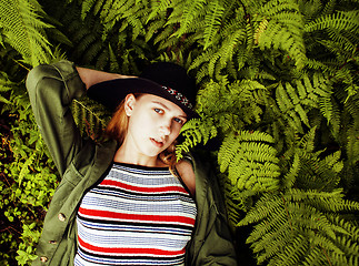 Image showing Pretty young blond girl hipster in hat among fern, vacation in green forest, lifestyle fashion people concept