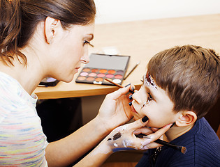 Image showing little cute child making facepaint on birthday party, zombie Apo