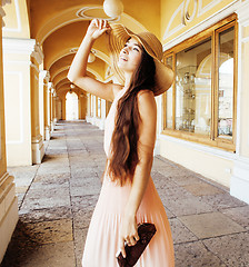 Image showing young pretty smiling woman in hat with bags on shopping at store