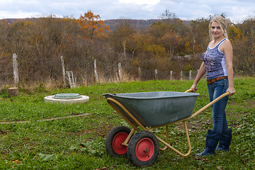 Image showing Blonde with a wheelbarrow